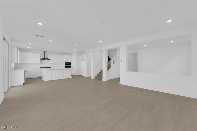 unfurnished living room featuring sink