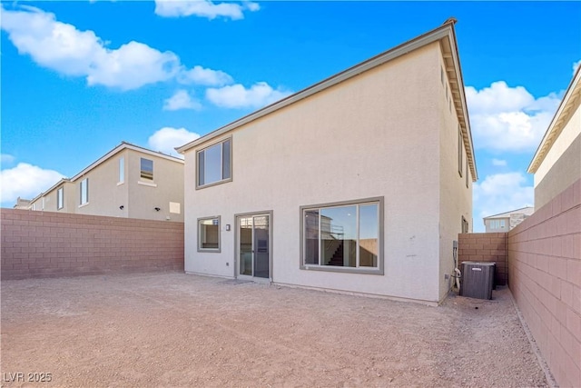 rear view of property with cooling unit and a patio