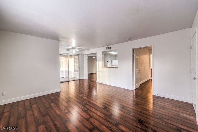 interior space with ceiling fan and dark hardwood / wood-style floors