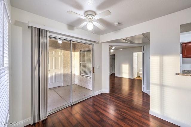 empty room with dark wood-type flooring and ceiling fan