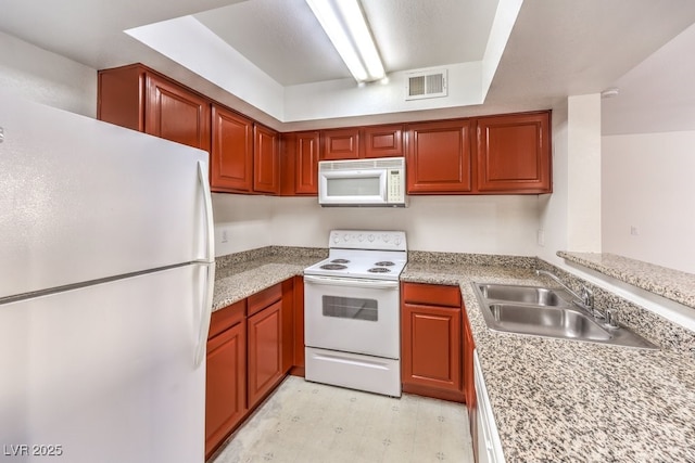 kitchen with sink and white appliances