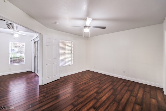 spare room with dark wood-type flooring and ceiling fan