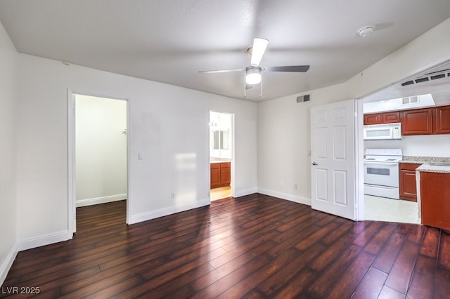 interior space with ceiling fan, white appliances, and dark hardwood / wood-style floors