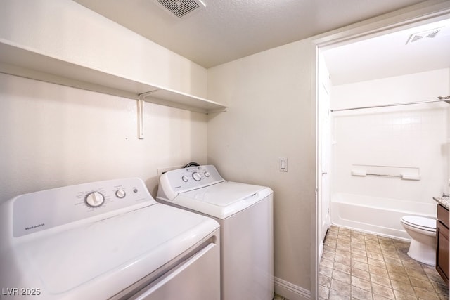 laundry room with washing machine and clothes dryer