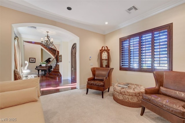 living area with arched walkways, visible vents, stairs, an inviting chandelier, and crown molding