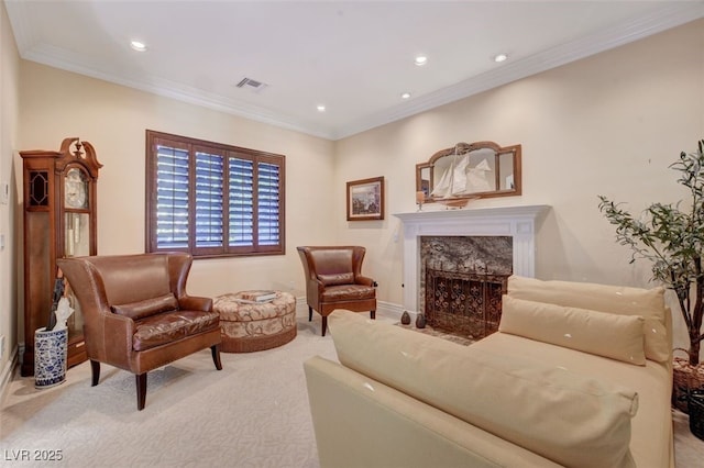 sitting room featuring carpet, a high end fireplace, and ornamental molding