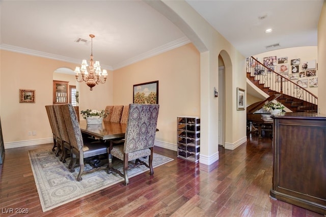 dining area featuring arched walkways, dark wood finished floors, visible vents, and baseboards