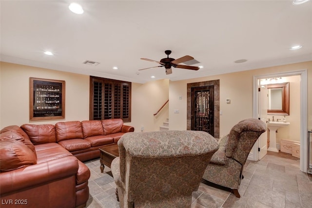 living area featuring stone finish flooring, stairs, visible vents, and recessed lighting