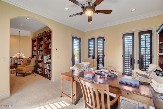 carpeted home office with ceiling fan with notable chandelier, french doors, and ornamental molding