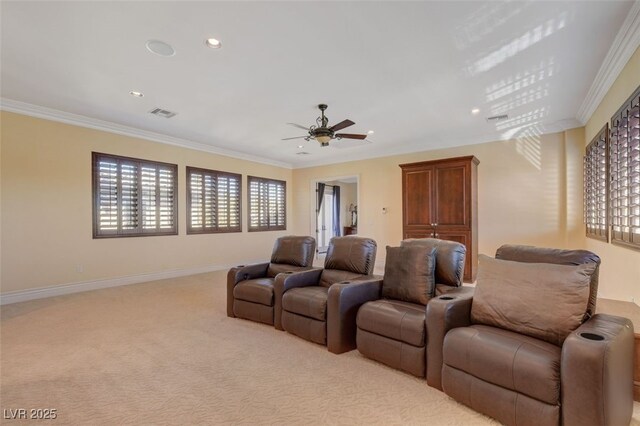 home theater room with light carpet, crown molding, and baseboards