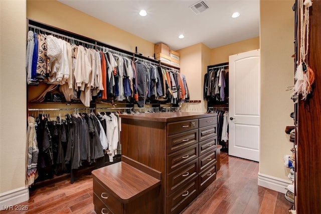 spacious closet featuring visible vents and wood finished floors