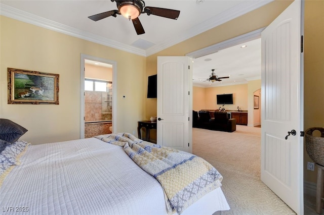 bedroom with ceiling fan, ensuite bathroom, light colored carpet, and crown molding