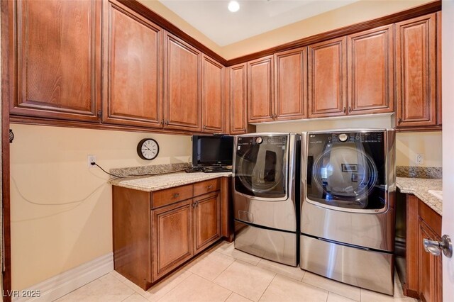 4450 Palisades Canyon Cir, Las Vegas, NV 89129 - washroom featuring washing machine and clothes dryer, light tile patterned floors, and cabinet space