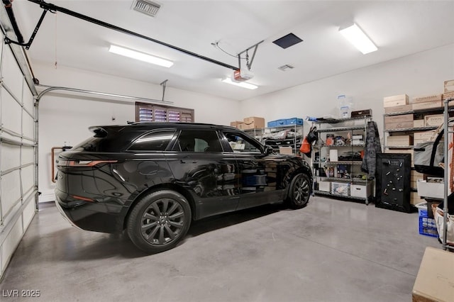 garage featuring visible vents and a garage door opener