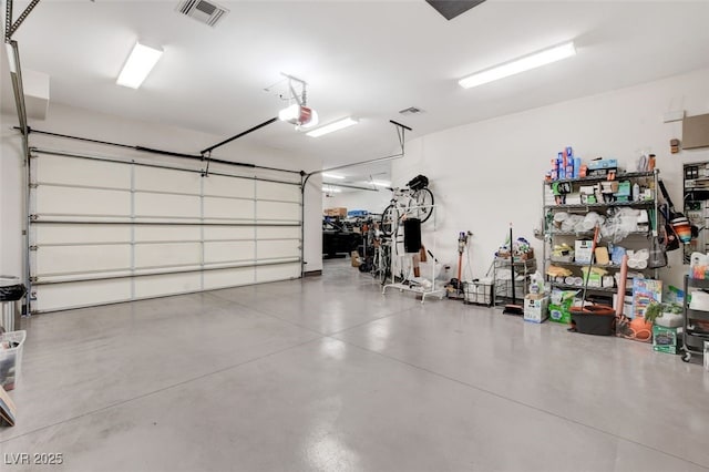 garage featuring visible vents and a garage door opener