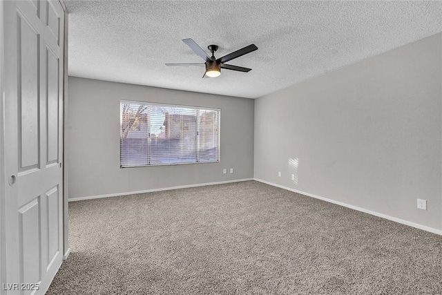 carpeted empty room with ceiling fan and a textured ceiling