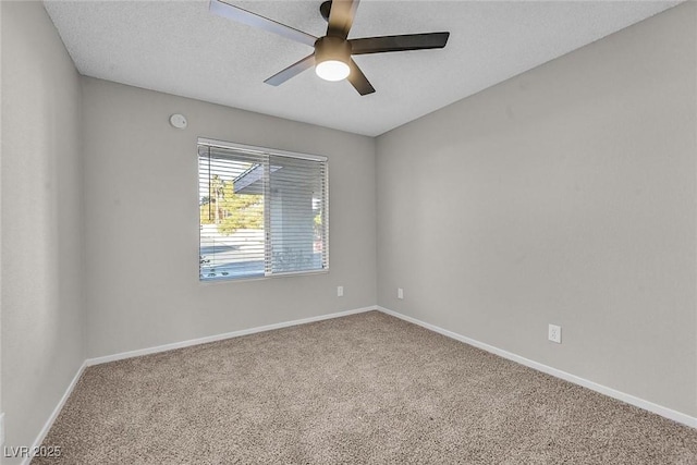 carpeted spare room with ceiling fan and a textured ceiling