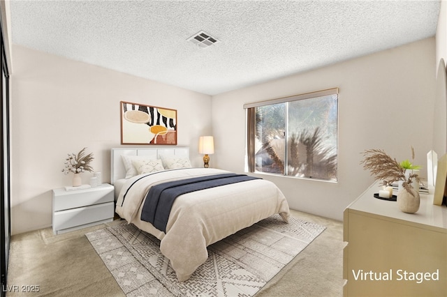 carpeted bedroom featuring a textured ceiling