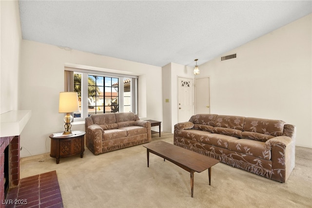 living room featuring carpet, a textured ceiling, vaulted ceiling, and a brick fireplace