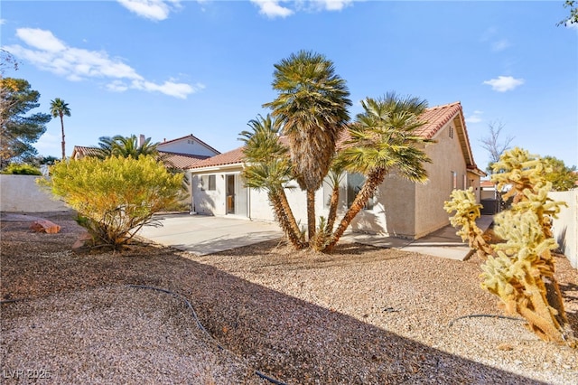 view of property exterior with a patio area