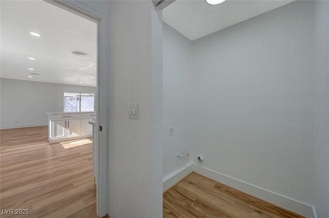 laundry room with light hardwood / wood-style flooring