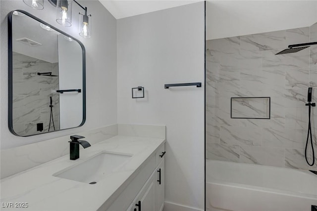 bathroom with vanity and tiled shower / bath