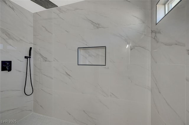 bathroom with a tile shower