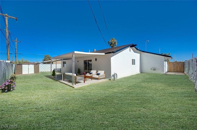 rear view of house with a patio, an outdoor hangout area, a yard, and a shed