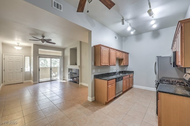 kitchen with ceiling fan, sink, stainless steel appliances, and light tile patterned flooring