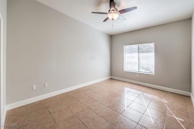 tiled spare room with ceiling fan