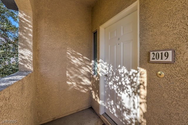 entrance to property with a balcony