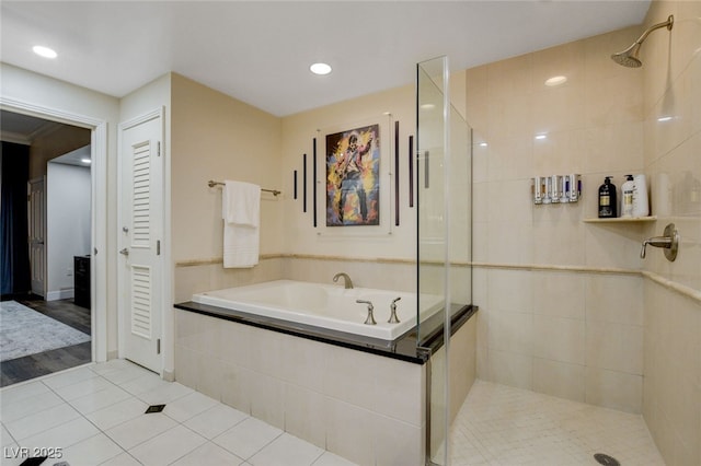 bathroom with independent shower and bath and tile patterned flooring