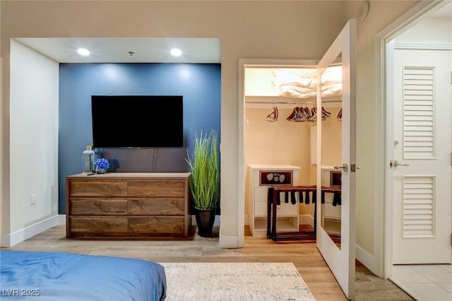 bedroom with light hardwood / wood-style flooring and a closet