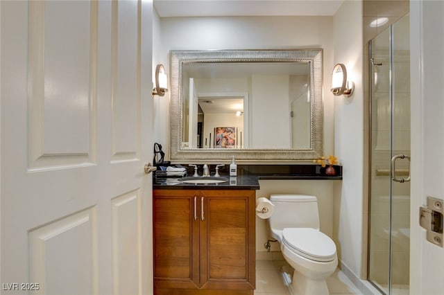 bathroom featuring toilet, tile patterned flooring, a shower with shower door, and vanity