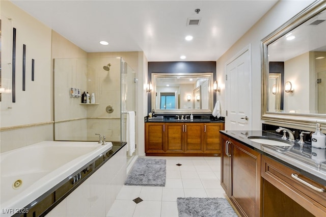 bathroom featuring tile patterned flooring, vanity, and shower with separate bathtub