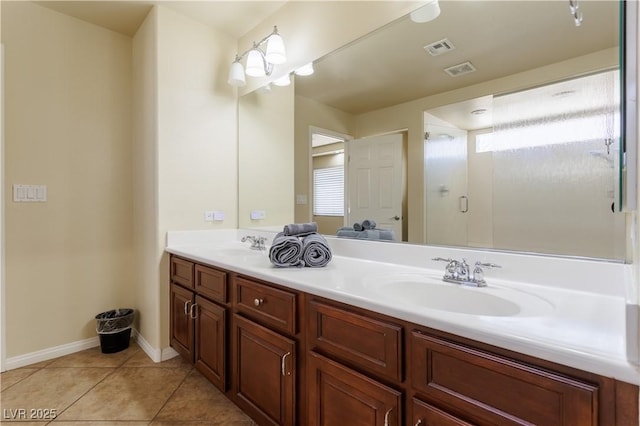 bathroom with vanity, tile patterned floors, and a shower with shower door