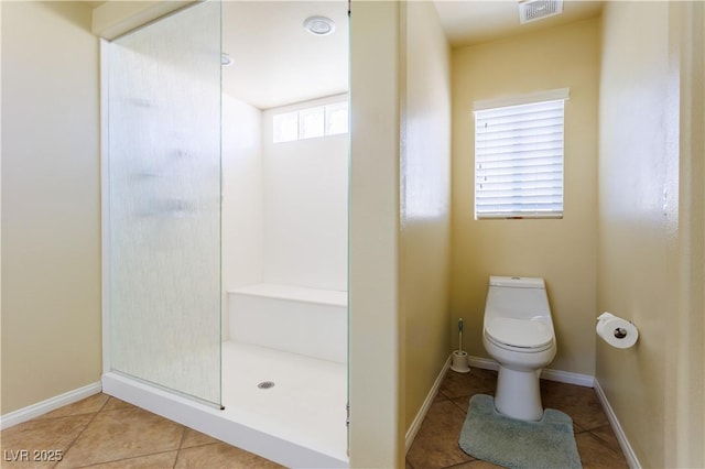 bathroom with walk in shower, tile patterned floors, and toilet