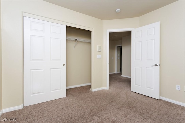 unfurnished bedroom with carpet floors and a closet