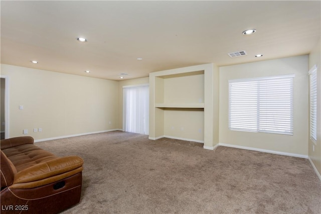 unfurnished living room featuring light carpet