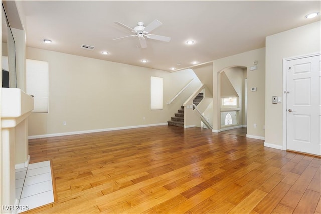 unfurnished living room with ceiling fan and light wood-type flooring