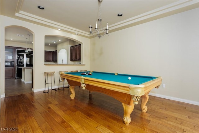 game room featuring a raised ceiling, hardwood / wood-style floors, and billiards