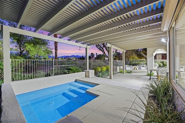 pool at dusk with a patio and a pergola