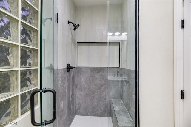 bathroom with a shower with shower door