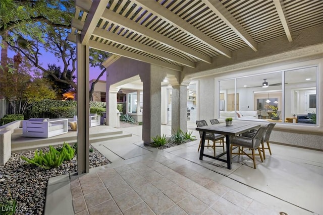 patio terrace at dusk featuring a pergola