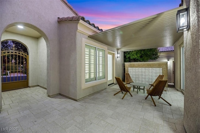 view of patio terrace at dusk