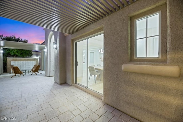 view of patio terrace at dusk