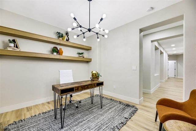 office area with a notable chandelier and light hardwood / wood-style floors