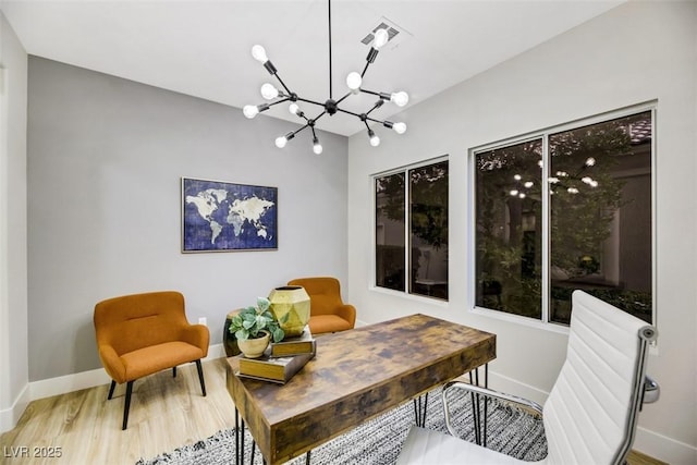 sitting room featuring hardwood / wood-style floors and a notable chandelier