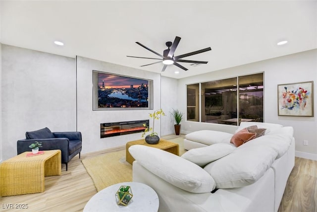 living room featuring light hardwood / wood-style floors and ceiling fan