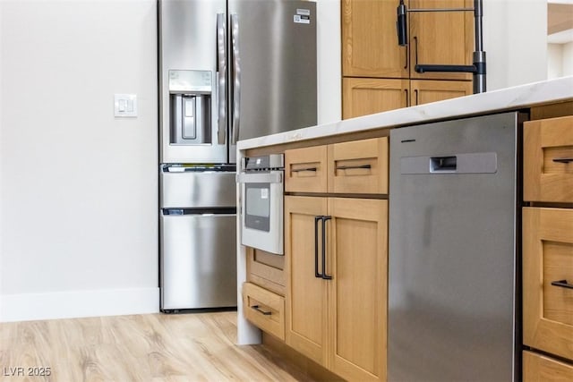 kitchen featuring stainless steel appliances and light wood-type flooring